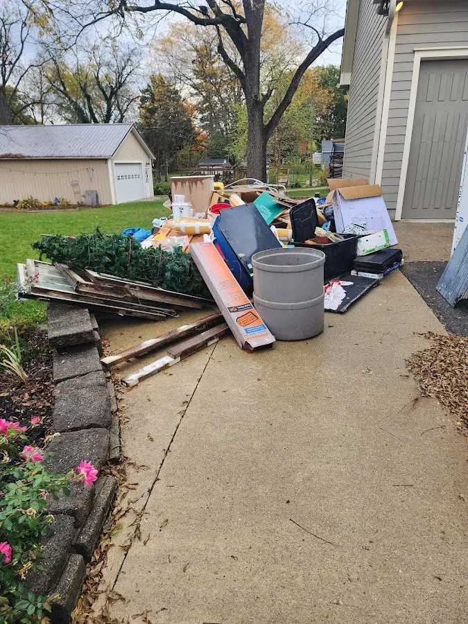 Dumpster being loaded with debris for Estate Cleanout Dumpster Rental in Live Oak